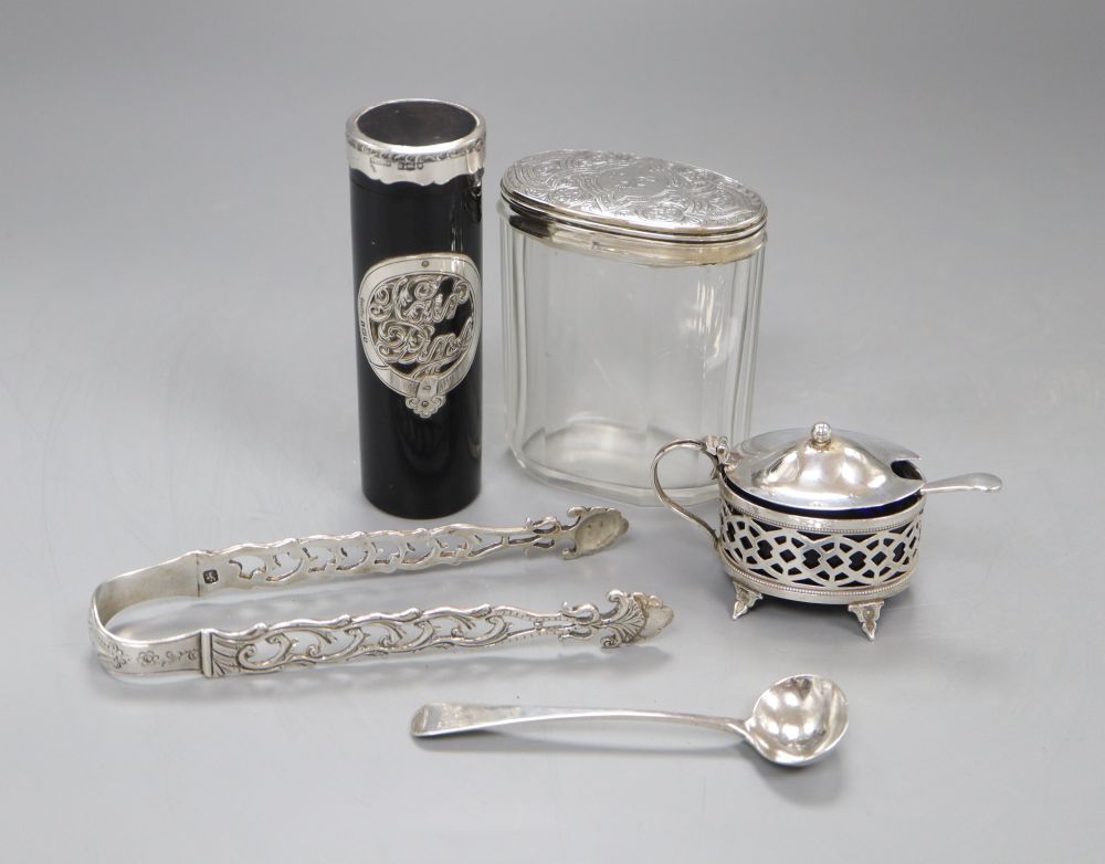A pair of Georgian silver sugar tongs, a George III mustard ladle, a silver mustard, mounted toilet jar and hair pin box.
